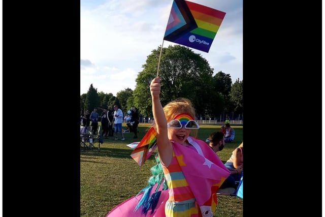 One young Pride goers proudly waves the flag.
