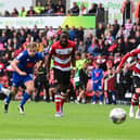 Harrogate Town's Jack Muldoon scores a penalty past Doncaster Rovers' Ian Lawlor.