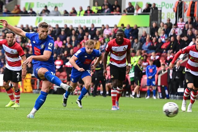 Harrogate Town's Jack Muldoon scores a penalty past Doncaster Rovers' Ian Lawlor.