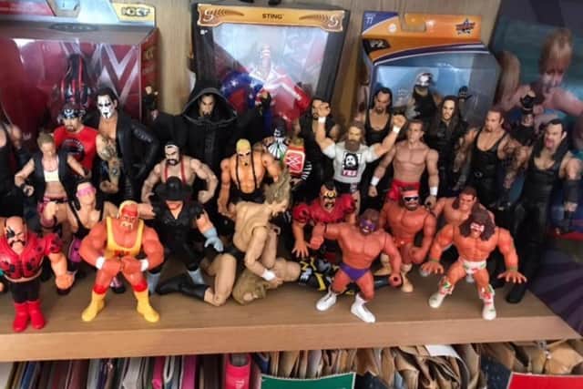 A shelf filled with WWE figurines.