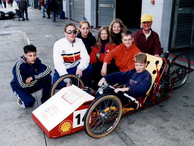 Adwick school pupils - left to right: Amthew Hewitt, Lee Matthews, Ja Hooton, Jamie Wilson, Andrew Cannell, Yvonne Preston, Graham Thorp, and driver Daniel Parkin Coates, pictured with their Shell EC car in May 1999