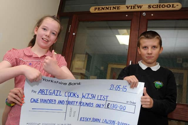 Abigail Cook and Ricky-John Lawson, after Ricky John saved up his pocked money to donate to an appeal in 2015