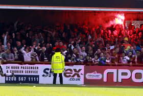 James Coppinger celebrates scoring in front of the Rovers fans at Brentford
