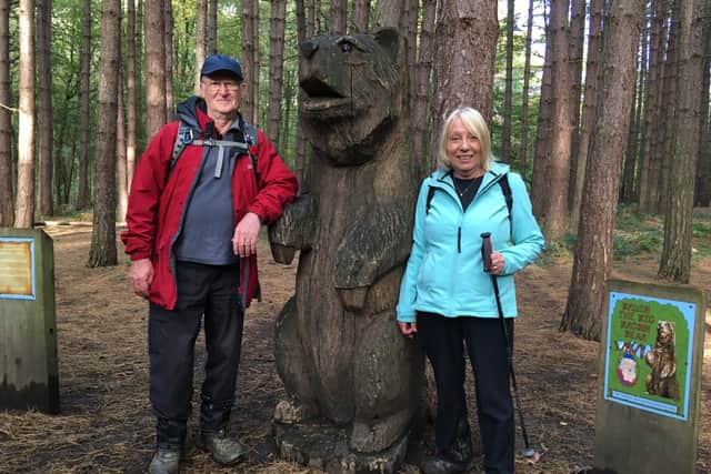 Norman and Wendy with the large wooden sculpture of a bear that now commemorates the story of a bear that escaped from a travelling menagerie in 1867.