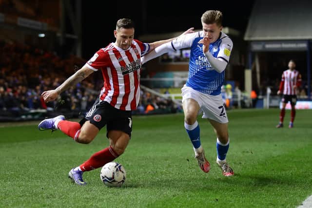 Sheffield United's Billy Sharp is tackled by Joe Tomlinson of Peterborough United. Photo: David Klein/Sportimage.