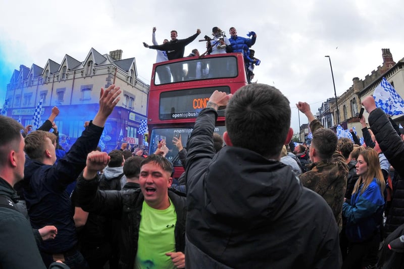 The Hartlepool United players and staff arrive on their open top bus tour as fans celebrate.