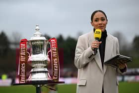 KETTERING, ENGLAND - DECEMBER 01: Pundit, Alex Scott stands with the FA Cup Trophy prior to the Emirates FA Cup Second Round match between Kettering Town and Doncaster Rovers at Latimer Park on December 01, 2024 in Kettering, England. (Photo by Shaun Botterill/Getty Images)