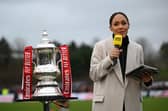 KETTERING, ENGLAND - DECEMBER 01: Pundit, Alex Scott stands with the FA Cup Trophy prior to the Emirates FA Cup Second Round match between Kettering Town and Doncaster Rovers at Latimer Park on December 01, 2024 in Kettering, England. (Photo by Shaun Botterill/Getty Images)