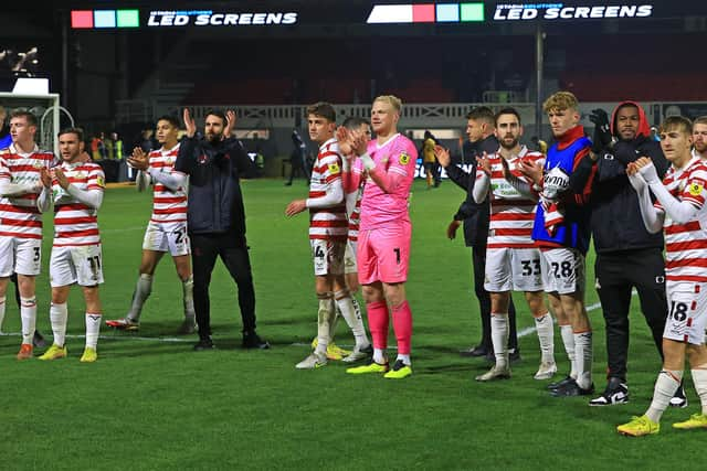 Doncaster Rovers players celebrate after victory against Newport County.