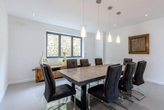 Contemporary and bright, the airy dining room is generously sized to accommodate both family and guests.
