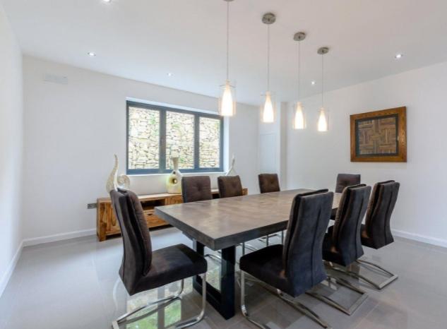 Contemporary and bright, the airy dining room is generously sized to accommodate both family and guests.
