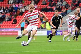 Doncaster's George Miller slots home from the spot against Crawley Town.