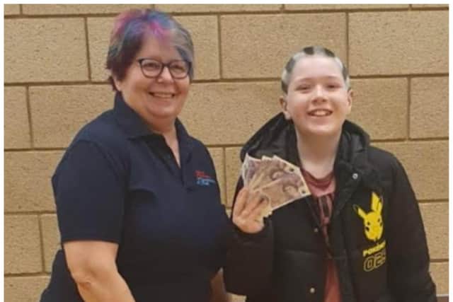 Kai handed over his cash to Jackie at Bullcroft Memorial Hall.