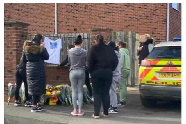 Floral tributes have been left outside the block of flats in Scawthorpe.