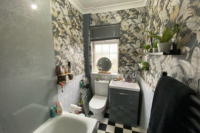 This bathroom comes with a three-piece suite, including a toilet, sink and shower/bath.