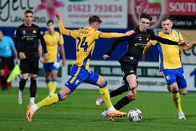 Doncaster Rovers' Louie Marsh dribbles past Mansfield Town's Lewis Brunt.