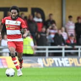 Doncaster Rovers have signed former Manchester United youngster Deji Sotona on a two-year deal following a trial.