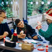 Artist Karen Hall showed the children how to make wreaths and sock snow men.