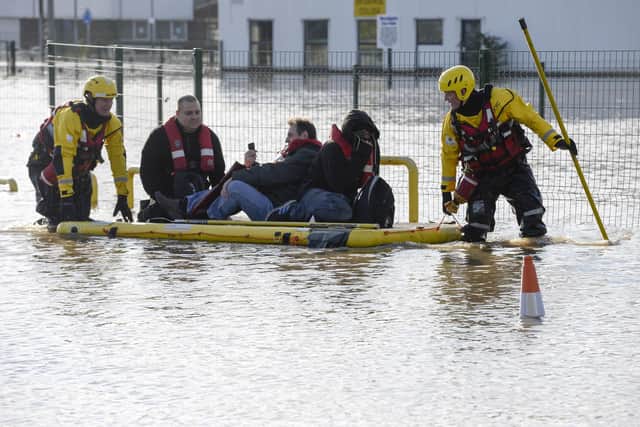 Workers are rescued by fire fighters from their factory in Doncaster as the River Don floods part of the town centre