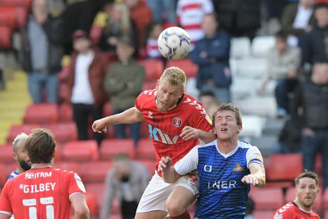 Tom Anderson is beaten to the ball by Jayden Stockley. Picture: Howard Roe/AHPIX