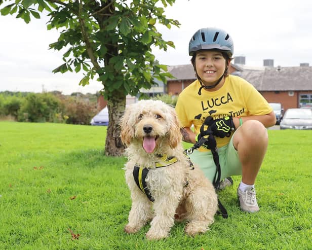 Lucca is pictured at Dogs Trust Leeds with nine month old Cockerpoo, Ralph, one of the rescue dogs his fundraising will help.