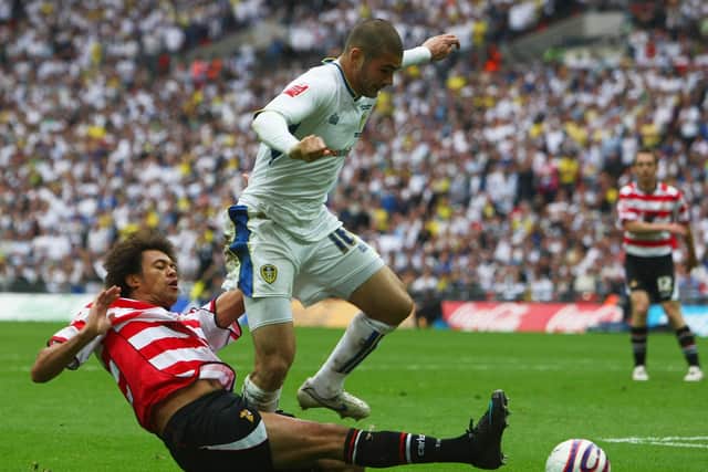 Bradley Johnson of Leeds United battles with Jason Price of Doncaster Rovers during the Coca Cola League 1 Playoff final (photo by Clive Rose/Getty Images).