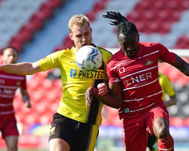 Joe Dodoo battles with Burton Albion's Thomas Hamer last season.