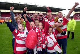 Doncaster Rovers fans celebrate victory over Dagenham and Redbridge in the play-off final, May 10, 2003