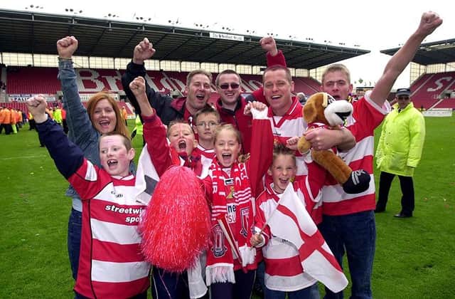 Doncaster Rovers fans celebrate victory over Dagenham and Redbridge in the play-off final, May 10, 2003