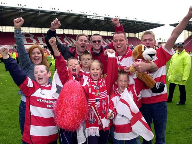 Doncaster Rovers fans celebrate victory over Dagenham and Redbridge in the play-off final, May 10, 2003