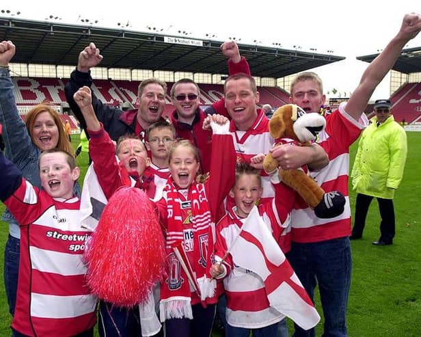 Doncaster Rovers fans celebrate victory over Dagenham and Redbridge in the play-off final, May 10, 2003