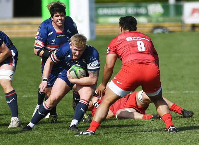 Doncaster's Conrad Cade takes on Saracens' Billy Vunipola.