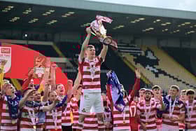 Rob Street holds aloft the League Two title. Pic: Howard Roe.