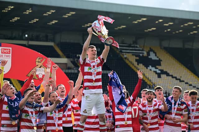 Rob Street holds aloft the League Two title. Pic: Howard Roe.