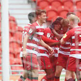 Rovers celebrate with Madger Gomes after his goal against Bristol Rovers