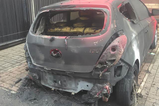 One of two cars torched at a Doncaster flats complex.