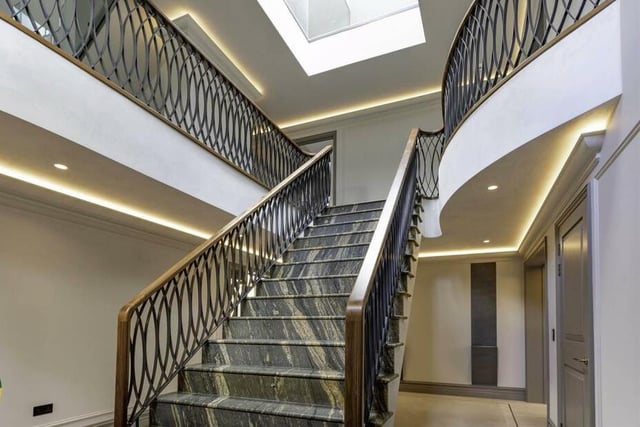 The staircase with walnut balustrade rises from the reception hallway.