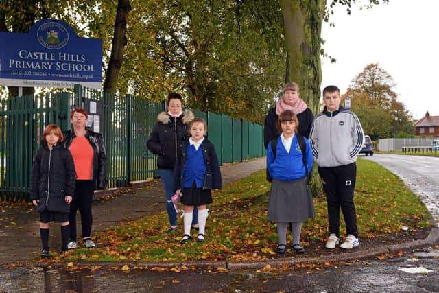Parents are appealing for road safety measures outside Castle Hills Primary School in Scawthorpe. Pictured outside the school on Jossey Lane are Nicola Tyas, Gabrielle Allen, Helen Ward, Nellie-Anne Ward-Cannon, Julie Murray, Abigail Murray and Daniel Murray.  Picture: NDFP-13-10-20 RoadSafety 1-NMSY