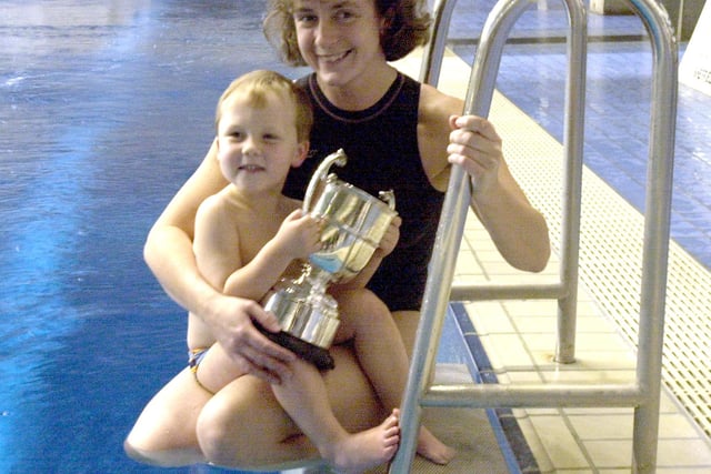 Three-year-old Harry Simpson with his swimming trophy and mother Lisa