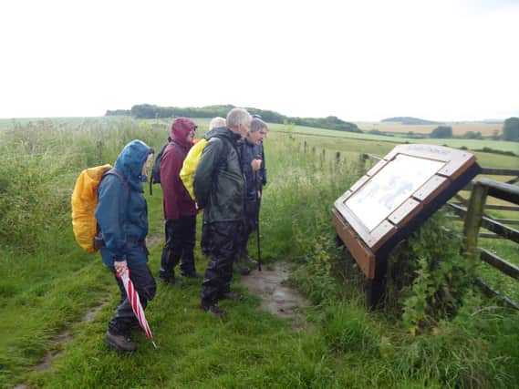Doncaster Ramblers in the rain reading the plaques