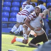 Adam Clayton celebrates with a fan after Doncaster Rovers' rescue a draw against AFC Wimbledon.