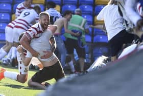 Adam Clayton celebrates with a fan after Doncaster Rovers' rescue a draw against AFC Wimbledon.