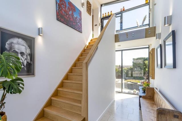 Many windows ensure a bright and airy interior, as in this hallway.
