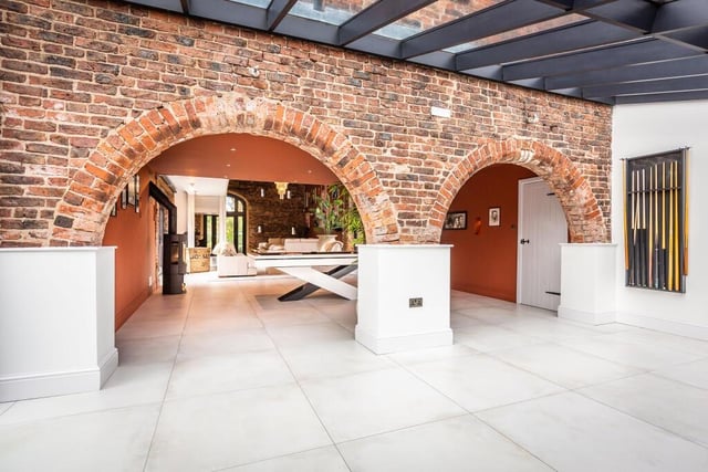 Archways featured in exposed brickwork.