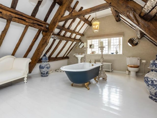 Another palatial bathroom, with rustic tones.