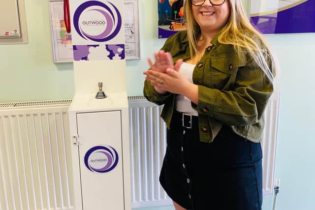 Using the hand sanitiser at the entrance to Outwood Academy Adwick