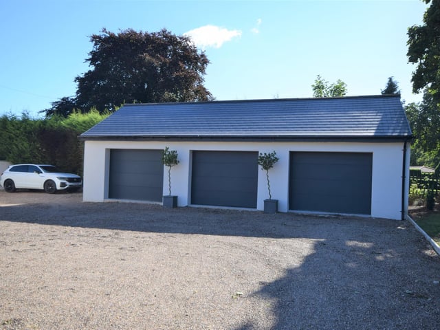 This property is approached by electric gates which open onto a sweeping driveway, which provides a number of off road parking spaces to the front, as well as the triple garage. The large gardens themselves are surrounded by hedging and walling to make it private.