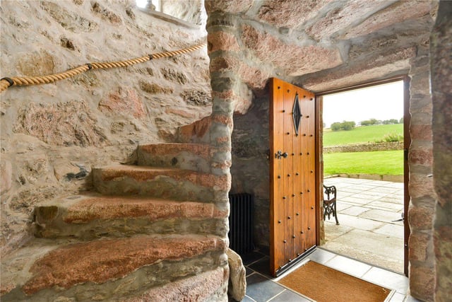 Entry to the historical tower house is through a studded, wood panelled front door.