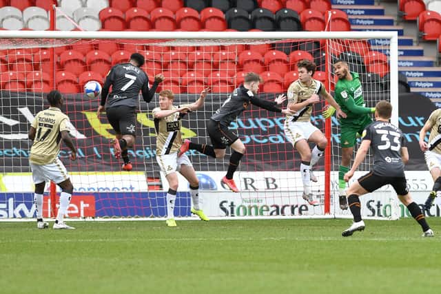 Former Rovers loanee Mallik Wilks heads in Hull's first goal at the Keepmoat. Picture: Andrew Roe/AHPIX