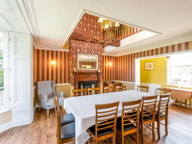 The formal dining room with gallery landing and library above.